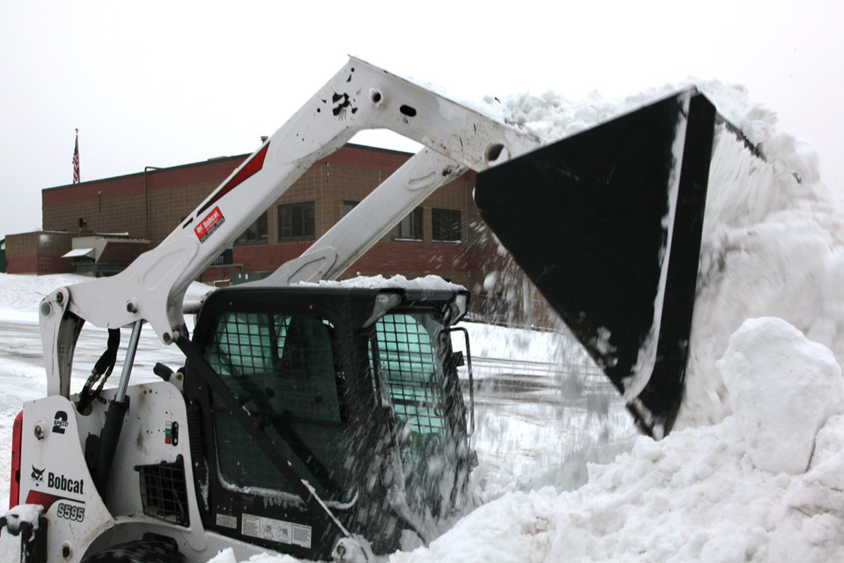 Piling up snow with a Bobcat